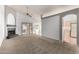 Spacious living room featuring a fireplace, carpet flooring, vaulted ceiling, and sliding doors to the outside at 3443 E Wickieup Ln, Phoenix, AZ 85050