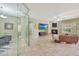 Bright living room featuring stone floors, a fireplace, comfortable seating and a large flatscreen TV at 3531 E Norwood Cir, Mesa, AZ 85213
