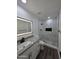 Modern bathroom with stylish tile shower, granite counters, and a black matte faucet at 3849 W Mauna Loa Ln, Phoenix, AZ 85053
