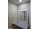 Bathroom vanity featuring granite counters, a decorative mirror, and ample storage at 3849 W Mauna Loa Ln, Phoenix, AZ 85053