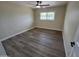 Bedroom featuring wood floors, a ceiling fan, and a window overlooking the outdoors at 3849 W Mauna Loa Ln, Phoenix, AZ 85053
