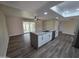 Spacious open kitchen with a large island, stainless steel appliances, and wood-look floors at 3849 W Mauna Loa Ln, Phoenix, AZ 85053