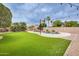 Lush backyard with artificial turf, mature landscaping, string lights, and a beautiful pool with waterfall feature at 4041 W Hackamore Dr, Phoenix, AZ 85083