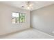 Well-lit bedroom featuring neutral walls, soft carpet, and a sunny window at 4041 W Hackamore Dr, Phoenix, AZ 85083