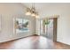 Dining area with hardwood floors and a view of the pool with a waterfall feature at 4041 W Hackamore Dr, Phoenix, AZ 85083