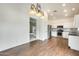 Dining area featuring wood floors and an open view into the kitchen and living areas at 4041 W Hackamore Dr, Phoenix, AZ 85083