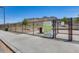 Community dog park with fenced enclosure, grassy area, and signage with park rules and guidelines at 4041 W Hackamore Dr, Phoenix, AZ 85083