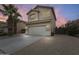 Charming two-story home featuring desert landscaping, a two car garage, and stylish exterior lighting at 4041 W Hackamore Dr, Phoenix, AZ 85083
