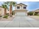 Inviting two-story home featuring a neutral color palette, a two car garage, and mature palm trees at 4041 W Hackamore Dr, Phoenix, AZ 85083