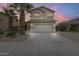 Inviting two-story home featuring a neutral color palette, a two car garage, and mature palm trees at 4041 W Hackamore Dr, Phoenix, AZ 85083