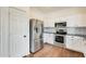 Well-equipped kitchen with stainless steel appliances, white cabinets, and hardwood floors at 4041 W Hackamore Dr, Phoenix, AZ 85083