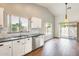 Bright kitchen featuring white cabinets, stainless steel appliances, granite countertops, and hardwood floors at 4041 W Hackamore Dr, Phoenix, AZ 85083