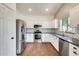 Modern kitchen featuring stainless steel appliances, white cabinets, and granite countertops at 4041 W Hackamore Dr, Phoenix, AZ 85083