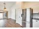 Kitchen area featuring a stainless steel refrigerator, white cabinets, and granite countertops at 4041 W Hackamore Dr, Phoenix, AZ 85083