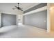 Spacious living room featuring neutral carpet, gray accent wall, and ample natural light at 4041 W Hackamore Dr, Phoenix, AZ 85083