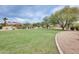 Expansive grassy area in the community park with mature trees and walking paths at 4041 W Hackamore Dr, Phoenix, AZ 85083