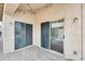 Outdoor patio with brick pavers, stucco walls, and sliding glass doors for easy indoor/outdoor living at 4041 W Hackamore Dr, Phoenix, AZ 85083