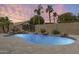 Beautiful pool with rock features and lush landscaping offers a serene backyard escape at 4041 W Hackamore Dr, Phoenix, AZ 85083