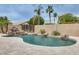 Backyard view of a pool with waterfall feature, bordered by desert landscaping and privacy fencing at 4041 W Hackamore Dr, Phoenix, AZ 85083