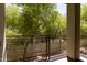 Balcony with black metal railings overlooking lush green trees, offering a private outdoor space at 4236 N 27Th St # 37, Phoenix, AZ 85016