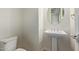 Clean half bathroom with a pedestal sink, oval mirror, and a low-flow toilet at 4236 N 27Th St # 37, Phoenix, AZ 85016