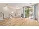 Bright living room with wood floors, modern railing, and sliding glass doors to a balcony at 4236 N 27Th St # 37, Phoenix, AZ 85016