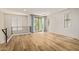 Bright living room with wood floors, modern railing, and sliding glass doors to a balcony at 4236 N 27Th St # 37, Phoenix, AZ 85016