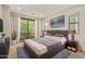 Comfortable main bedroom with plush gray carpet and a sliding glass door to the outdoor patio at 4236 N 27Th St # 37, Phoenix, AZ 85016