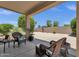 Inviting backyard patio with stone gravel, plants, seating and desert landscaping at 4332 E Cassia Ln, Gilbert, AZ 85298