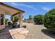 Inviting backyard patio with stone gravel, plants, desert landscaping and covered patio at 4332 E Cassia Ln, Gilbert, AZ 85298