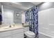Bright bathroom with a blue floral shower curtain and a large mirror over the sink at 4332 E Cassia Ln, Gilbert, AZ 85298