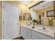 Bathroom features a double sink vanity, large mirror, and a plant at 4332 E Cassia Ln, Gilbert, AZ 85298