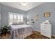 Cozy bedroom with a ceiling fan, a window with shutters, and light blue walls at 4332 E Cassia Ln, Gilbert, AZ 85298
