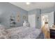 Comfortable bedroom with light blue walls, closet, wood floors and view into the Living Room at 4332 E Cassia Ln, Gilbert, AZ 85298