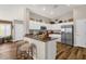 Bright kitchen features an island with bar seating, stainless steel appliances, and decor on top of the cabinets at 4332 E Cassia Ln, Gilbert, AZ 85298