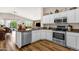 Bright kitchen with white cabinets, stainless steel appliances, and hardwood flooring at 4332 E Cassia Ln, Gilbert, AZ 85298