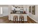 Bright kitchen features an island with bar seating, stainless steel appliances, and decor on top of the cabinets at 4332 E Cassia Ln, Gilbert, AZ 85298