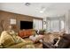 Inviting living room featuring wood-look floors, comfortable seating, and a ceiling fan at 4332 E Cassia Ln, Gilbert, AZ 85298