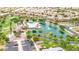 Aerial view of the community with a pool, pond with fountains, park, and lush landscaping at 43615 W Roth Rd, Maricopa, AZ 85138