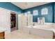 Bathroom featuring a separate shower, soaking tub, and walk-in closet at 43615 W Roth Rd, Maricopa, AZ 85138