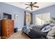 Comfortable bedroom with blue accent wall, hardwood floors and natural light at 43615 W Roth Rd, Maricopa, AZ 85138