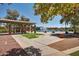A scenic community lake with water features, covered seating, and walking paths for outdoor enjoyment at 43615 W Roth Rd, Maricopa, AZ 85138