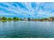 Picturesque pond with a central fountain and lush greenery, enhanced by shade structures, creating a scenic community gathering spot at 43615 W Roth Rd, Maricopa, AZ 85138