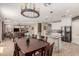 Spacious open kitchen and dining area with modern appliances and stone accents at 43615 W Roth Rd, Maricopa, AZ 85138