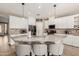 Modern kitchen featuring a large island with seating and pendant lighting at 43615 W Roth Rd, Maricopa, AZ 85138