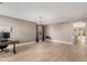 Open-concept living area with neutral walls, tile flooring and accent lighting at 43615 W Roth Rd, Maricopa, AZ 85138