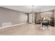 Bright, open-concept living room with tile floors and a modern light fixture at 43615 W Roth Rd, Maricopa, AZ 85138