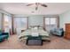 Main bedroom with natural light, ceiling fan, and a comfortable seating area at 43615 W Roth Rd, Maricopa, AZ 85138