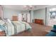 Spacious main bedroom with a ceiling fan, access to main bath, and neutral colors at 43615 W Roth Rd, Maricopa, AZ 85138