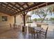 Outdoor patio area with dining tables and chairs, perfect for gatherings or enjoying the view of the nearby lake at 43615 W Roth Rd, Maricopa, AZ 85138